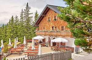 The Dr-Friedrich-Oedl-Schutzhaus is a rustic alpine guesthouse with a wooden balcony with flower boxes and is surrounded by pine trees. Enjoy the seating on the terrace and the view of the famous Eisriesenwelt.